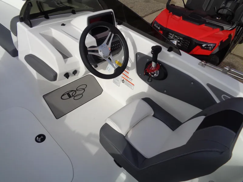 Slide: The Image of 2024 Tahoe T21 boat cockpit with steering wheel and captain's chair. - 9