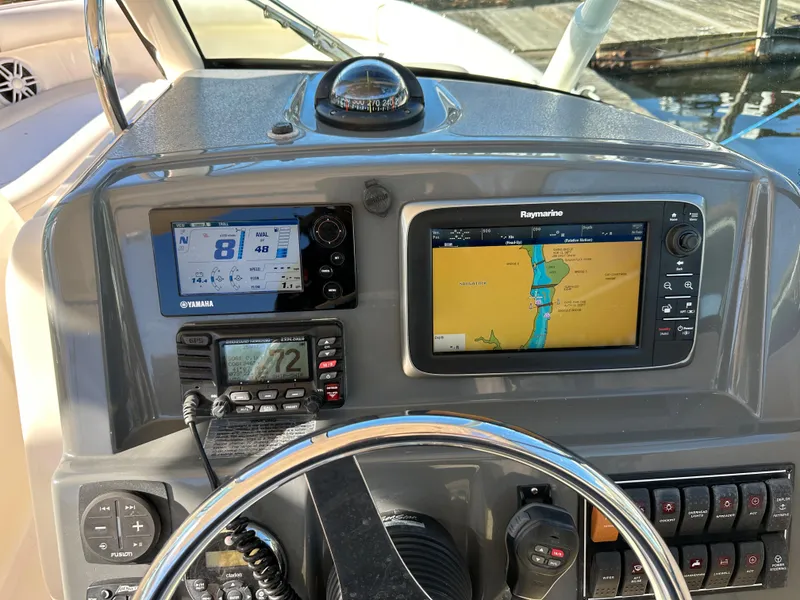 Slide: The Image of 2012 Pursuit DC 265 Dual Console dashboard with navigation and control systems. - 12