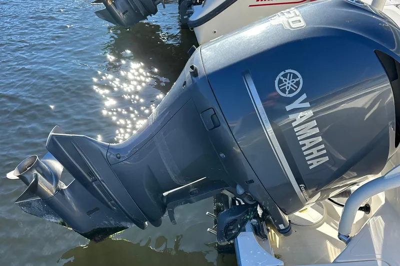 Slide: The Image of Yamaha outboard motor on a 2012 Pursuit DC 265 Dual Console boat. - 18