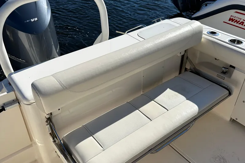 Slide: The Image of 2012 Pursuit DC 265 Dual Console boat with white cushioned seating and Yamaha outboard motor. - 20