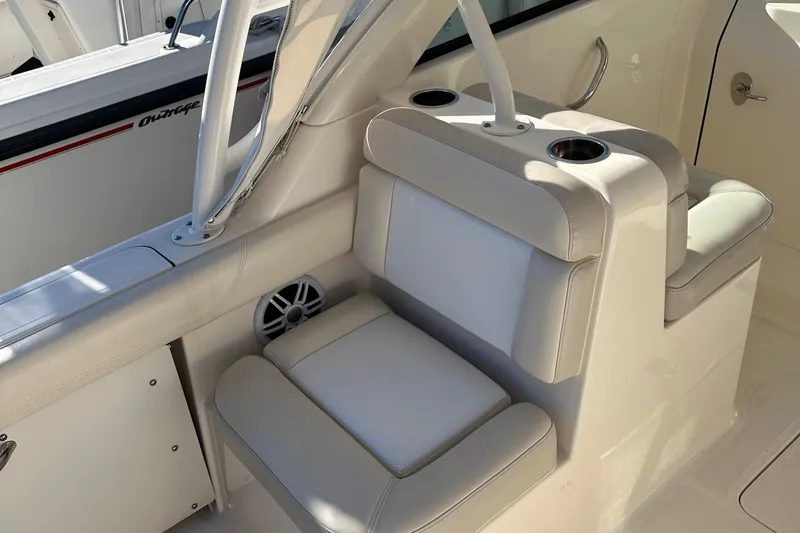 Slide: The Image of 2012 Pursuit DC 265 Dual Console boat interior seating and cup holders. - 21