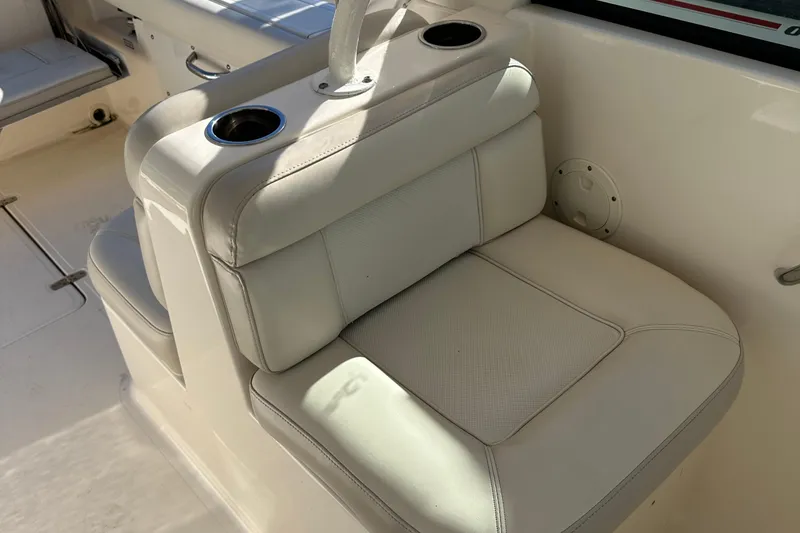 Slide: The Image of 2012 Pursuit DC 265 Dual Console boat seat with cup holders. - 22