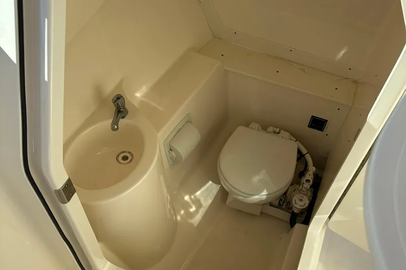 Slide: The Image of 2012 Pursuit DC 265 Dual Console boat bathroom with sink and toilet - 23