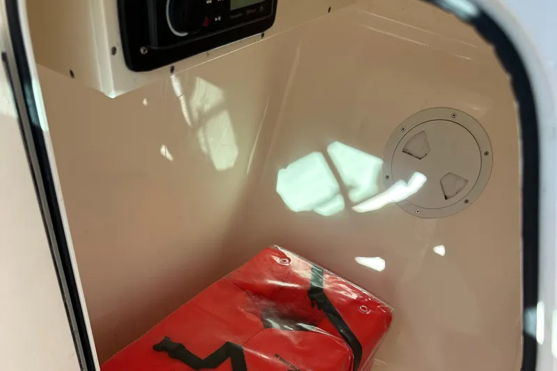 Slide: The Image of Interior of 2012 Pursuit DC 265 Dual Console boat with safety equipment. - 24