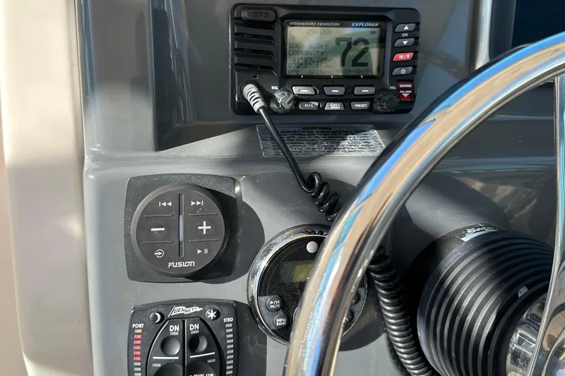 Slide: The Image of Close-up of 2012 Pursuit DC 265 Dual Console boat dashboard controls. - 25
