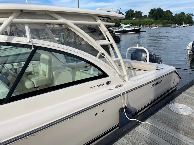 Slide: The Image of 2012 Pursuit DC 265 Dual Console boat docked at marina. - 4