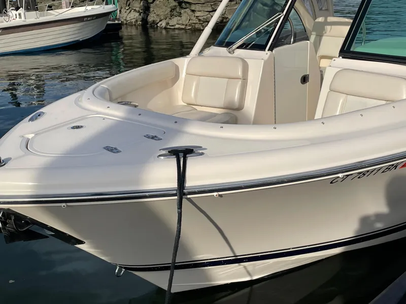 Slide: The Image of 2012 Pursuit DC 265 Dual Console boat docked in a marina. - 5