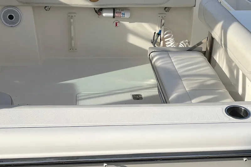 Slide: The Image of 2012 Pursuit DC 265 Dual Console boat interior with seating and storage. - 7