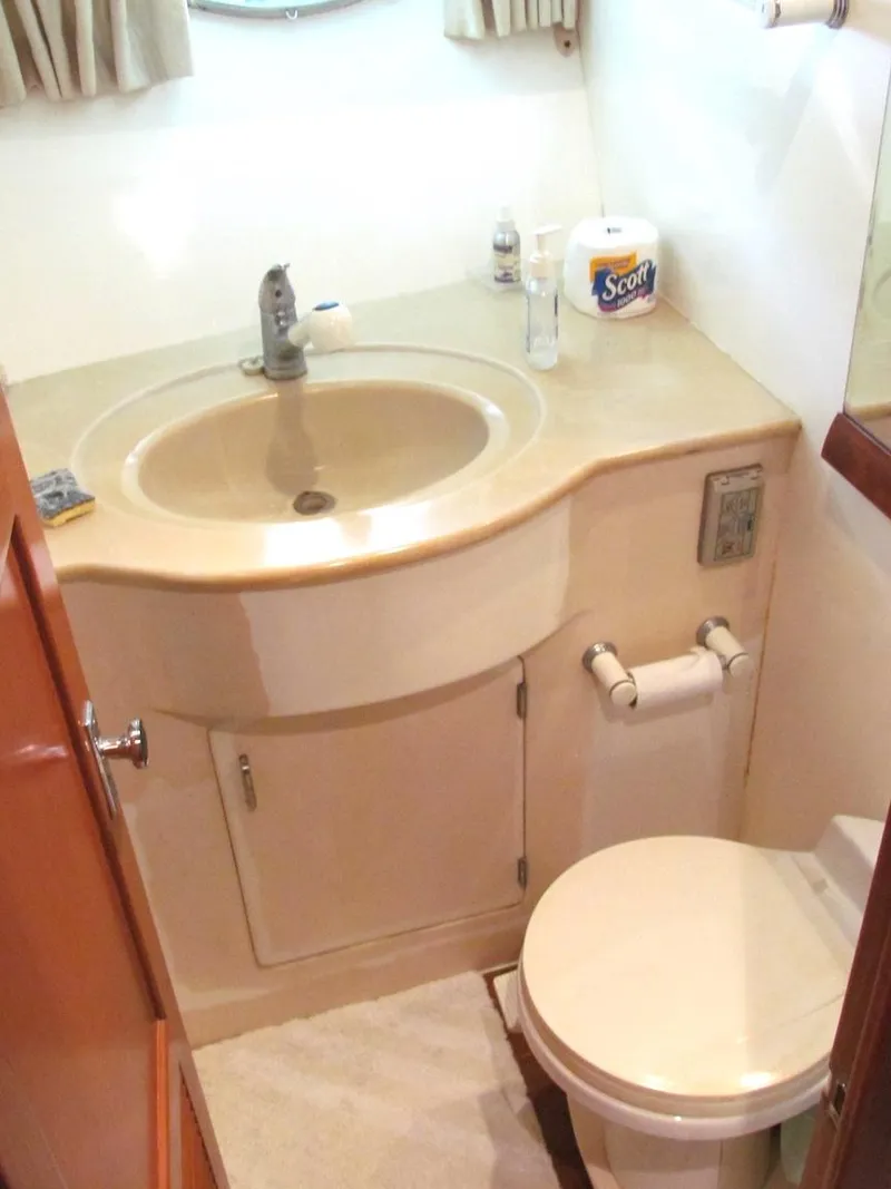 Slide: The Image of Compact bathroom in a 1997 Hyatt 55 yacht with sink and toilet. - 14