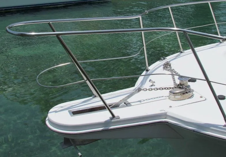 Slide: The Image of Bow of a 1997 Hyatt 55 yacht with anchor chain and clear water. - 2