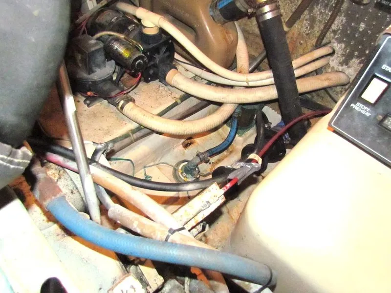 Slide: The Image of Engine compartment of a 1997 Hyatt 55 boat with various hoses and wiring. - 31