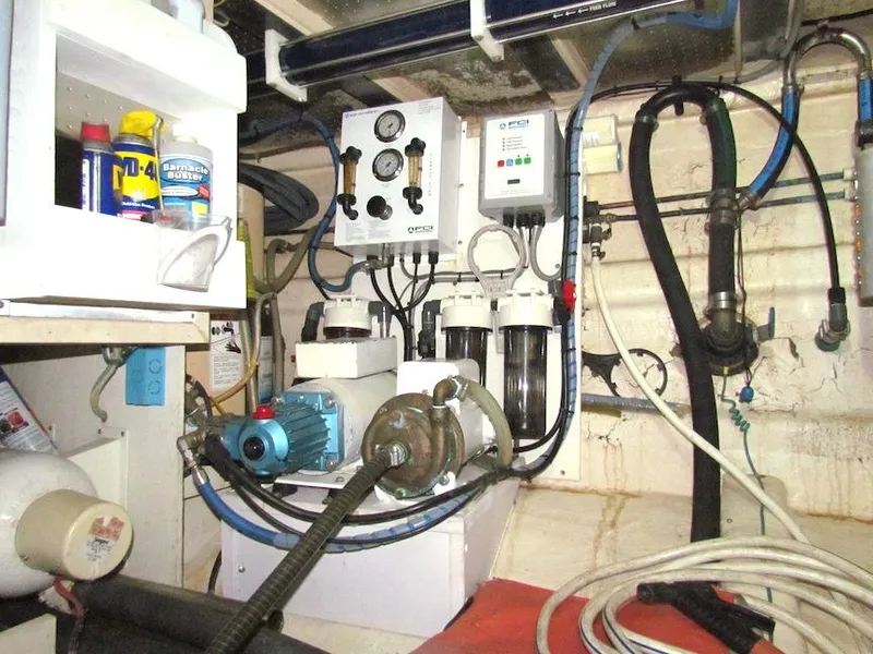 Slide: The Image of Engine room of a 1997 Hyatt 55 yacht with various mechanical components and tools. - 35