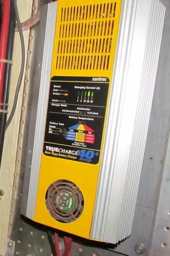 Slide: The Image of Yellow and silver Xantrex TrueCharge 40+ battery charger mounted on a wall. - 37