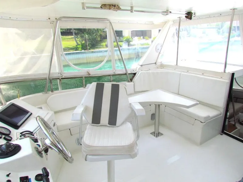 Slide: The Image of Interior of 1997 Hyatt 55 yacht with white seating and steering area. - 6