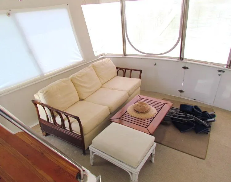 Slide: The Image of 1997 Hyatt 55 yacht interior with beige sofa, table, and ottoman. - 7