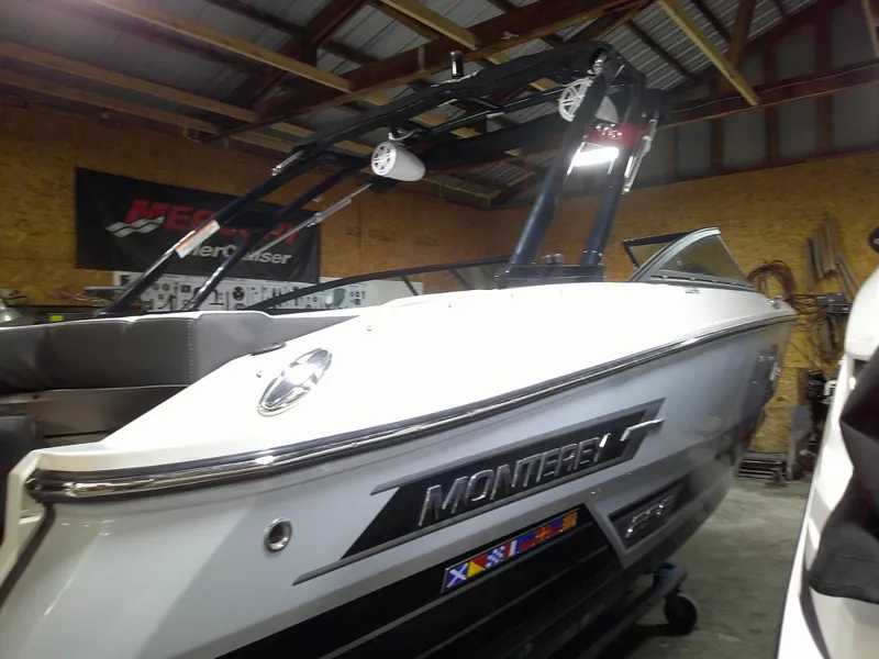 Slide: The Image of 2023 Monterey 238 Super Sport boat in a garage. - 2
