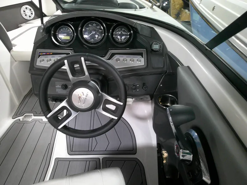 Slide: The Image of 2023 Monterey 238 Super Sport boat dashboard with steering wheel and instrument panel. - 5