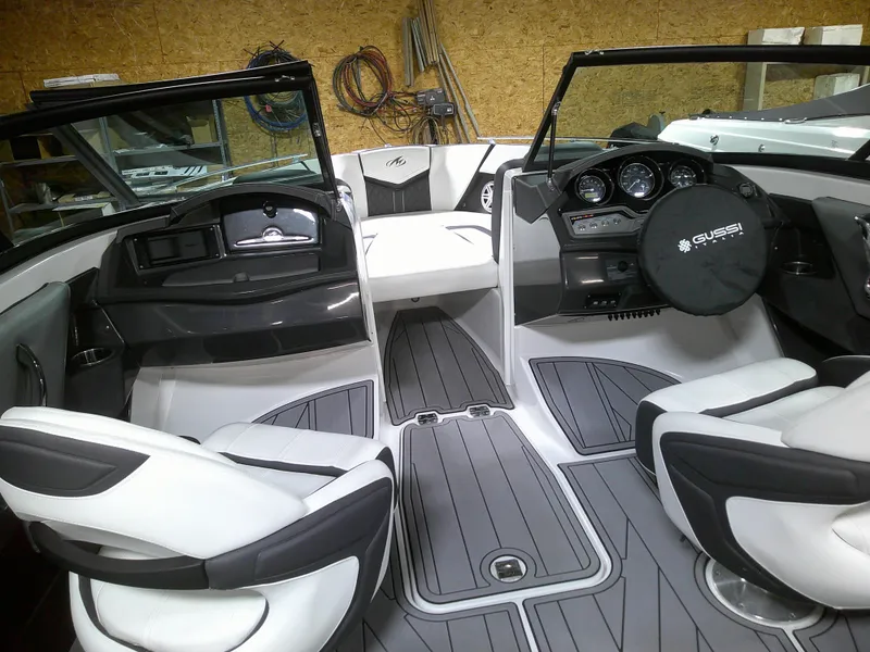 Slide: The Image of 2023 Monterey 238 Super Sport boat interior with modern dashboard and seating. - 6