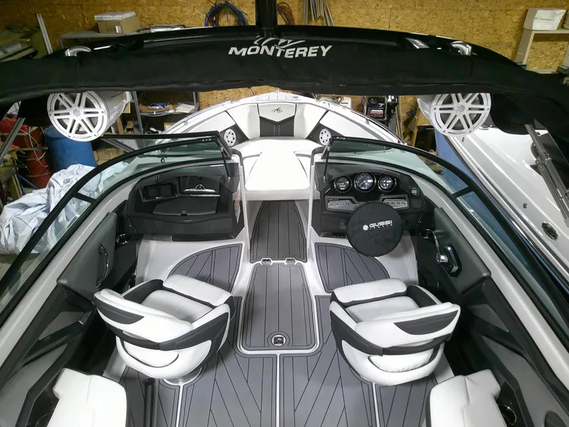 Slide: The Image of 2023 Monterey 238 Super Sport boat interior with modern seating and dashboard. - 7