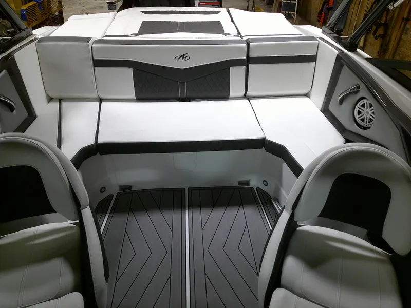 Slide: The Image of 2023 Monterey 238 Super Sport boat interior with white and black seating. - 8