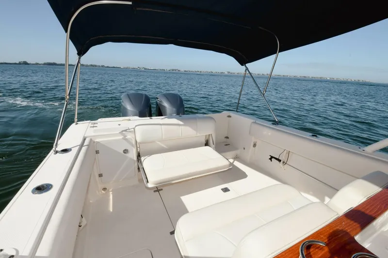 Slide: The Image of 2011 Pursuit S310 boat with twin engines and spacious seating on open water. - 15