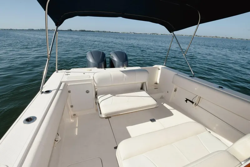 Slide: The Image of 2011 Pursuit S310 boat with twin engines and spacious seating on open water. - 17