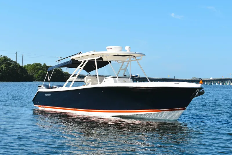 Slide: The Image of 2011 Pursuit S310 boat on calm water with a bridge in the background. - 20
