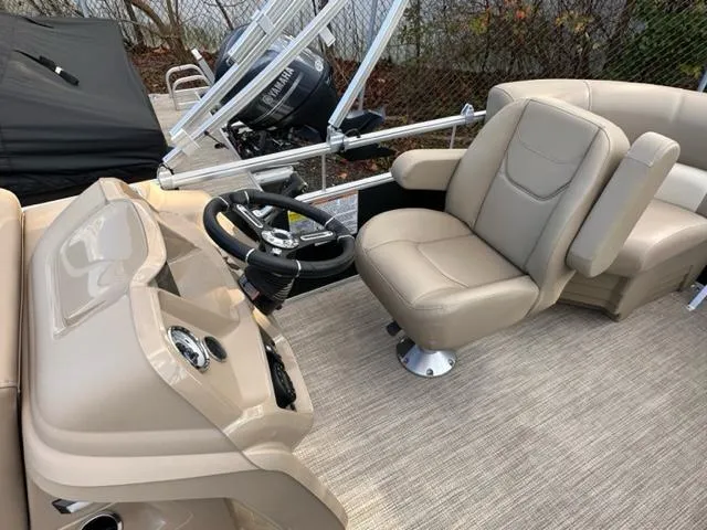 Slide: The Image of 2024 Starcraft LX 18 F boat interior with beige captain's chair and steering console. - 3