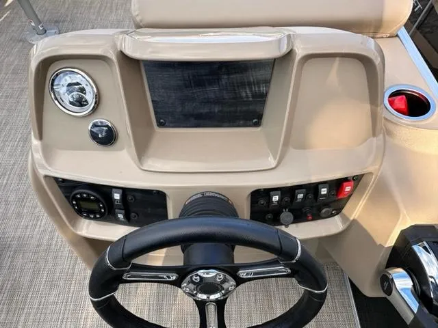 Slide: The Image of 2024 Starcraft LX 18 F boat dashboard with steering wheel and control panel. - 4