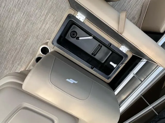 Slide: The Image of 2024 Starcraft LX 18 F boat interior storage compartment and cup holders. - 5