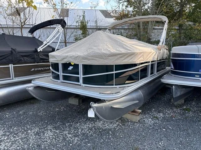 Slide: The Image of 2024 Starcraft LX 18 F pontoon boat with cover in storage. - 7