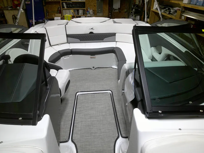 Slide: The Image of 2023 Monterey 224FS boat interior with white and gray seating. - 5