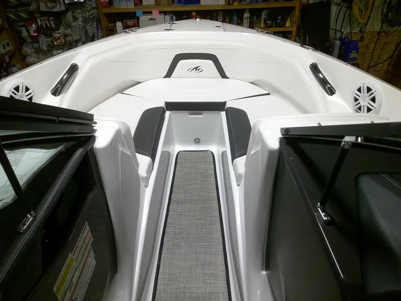 Slide: The Image of 2023 Monterey 224FS boat interior with open bow seating and storage compartments. - 6