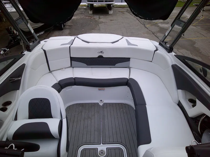 Slide: The Image of 2023 Monterey 224FS boat interior with white and gray seating. - 4