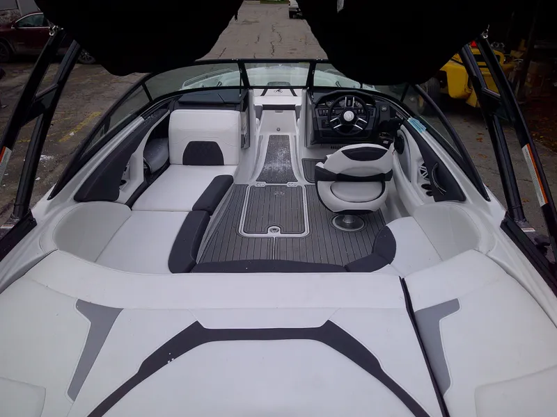 Slide: The Image of 2023 Monterey 224FS boat interior with white and gray seating and modern dashboard. - 6