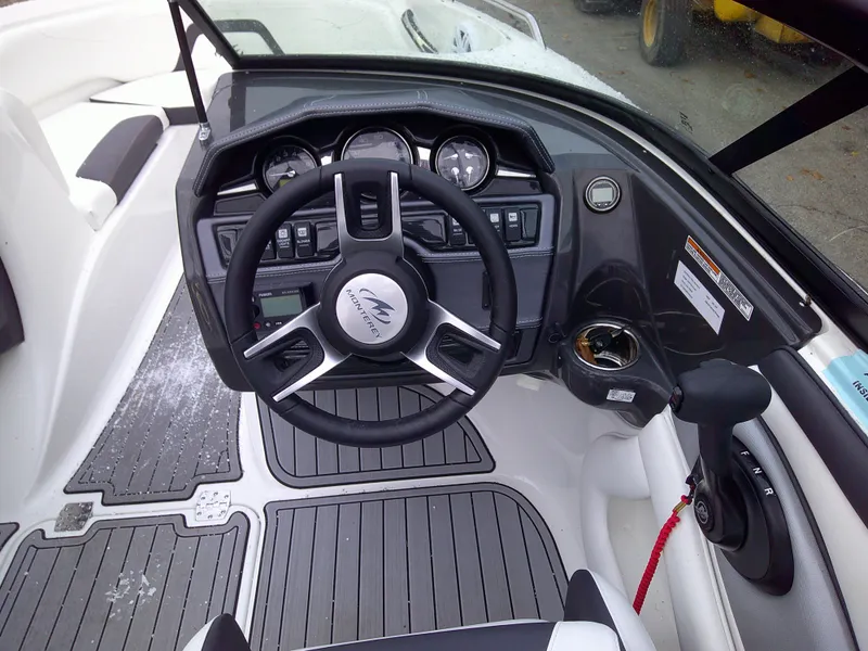 Slide: The Image of 2023 Monterey 224FS boat cockpit with steering wheel and control panel. - 7