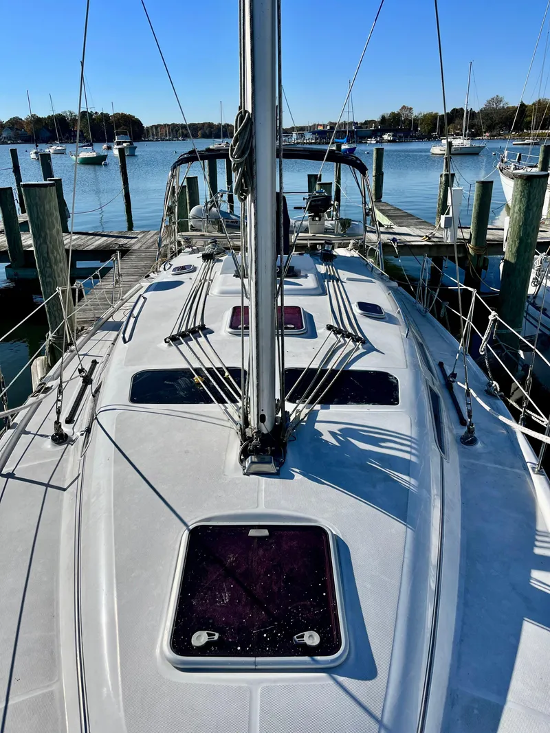 Slide: The Image of 2008 Hunter 38 sailboat docked at marina, clear sky, calm water. - 10