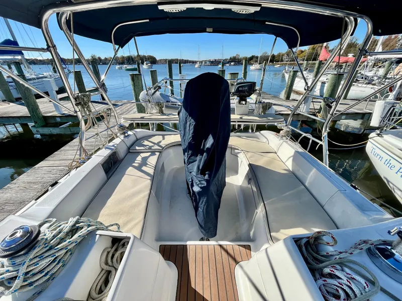 Slide: The Image of 2008 Hunter 38 sailboat cockpit with covered helm, docked at marina. - 11