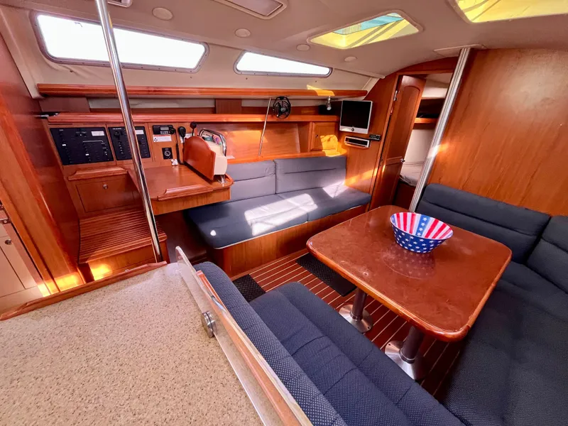 Slide: The Image of Interior of 2008 Hunter 38 sailboat with cozy seating and wooden finishes. - 2