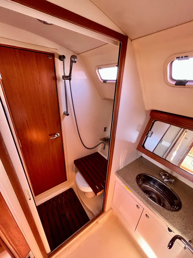Slide: The Image of 2008 Hunter 38 yacht bathroom with shower, sink, and wooden accents. - 20