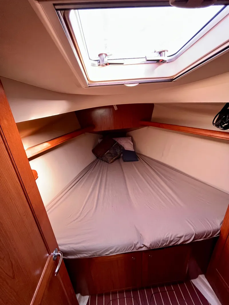 Slide: The Image of Cozy cabin interior of 2008 Hunter 38 sailboat with skylight and wooden finish. - 21