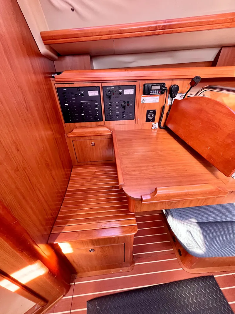 Slide: The Image of 2008 Hunter 38 sailboat interior with navigation station and wooden cabinetry. - 22
