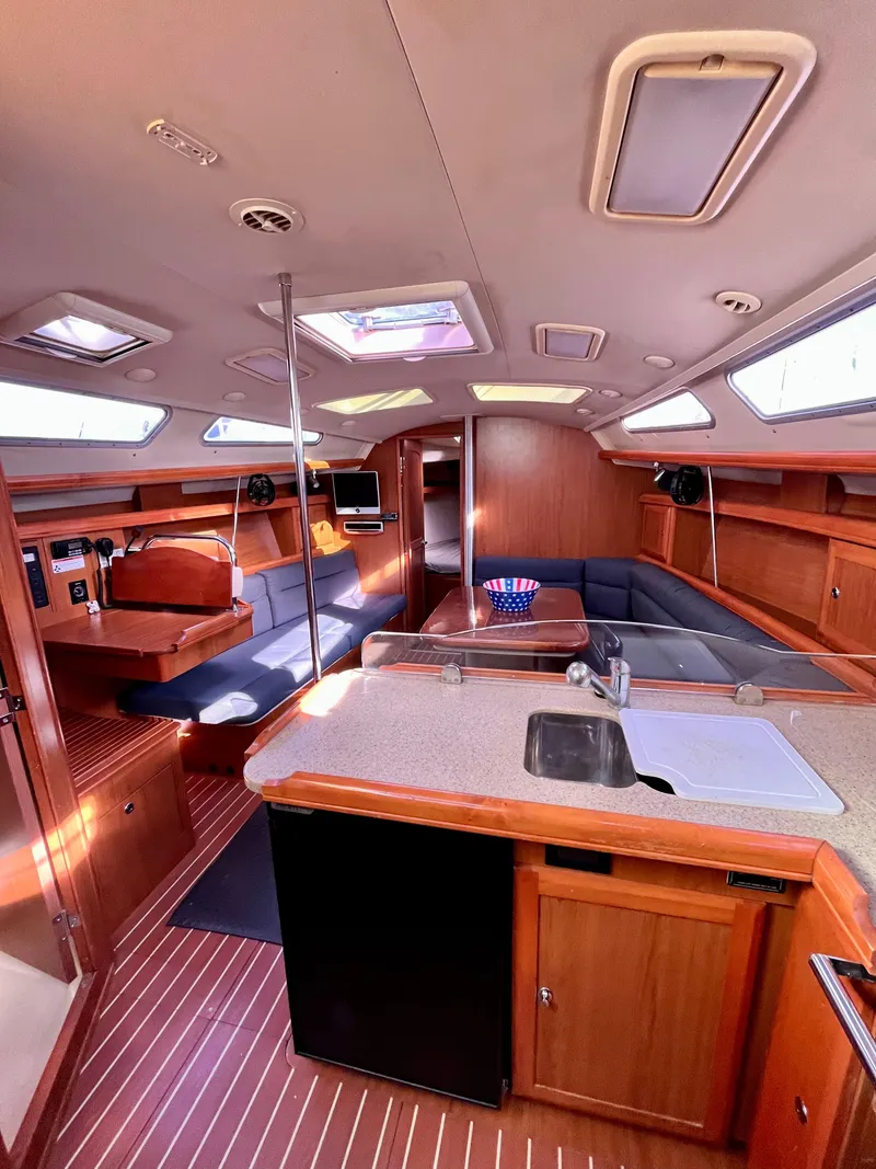 Slide: The Image of Interior of 2008 Hunter 38 sailboat with modern kitchen and seating area. - 23