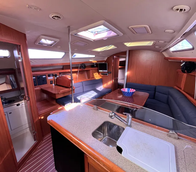 Slide: The Image of Interior of 2008 Hunter 38 sailboat with modern kitchen and seating area. - 24