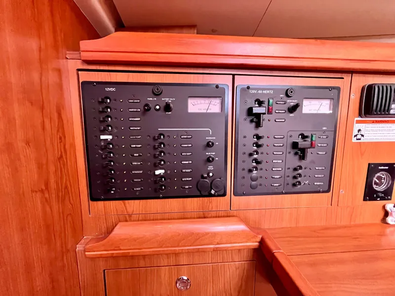 Slide: The Image of Electrical control panel on a 2008 Hunter 38 sailboat, featuring switches and gauges. - 25
