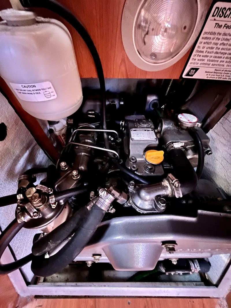 Slide: The Image of Engine compartment of a 2008 Hunter 38 sailboat, featuring various mechanical components. - 27