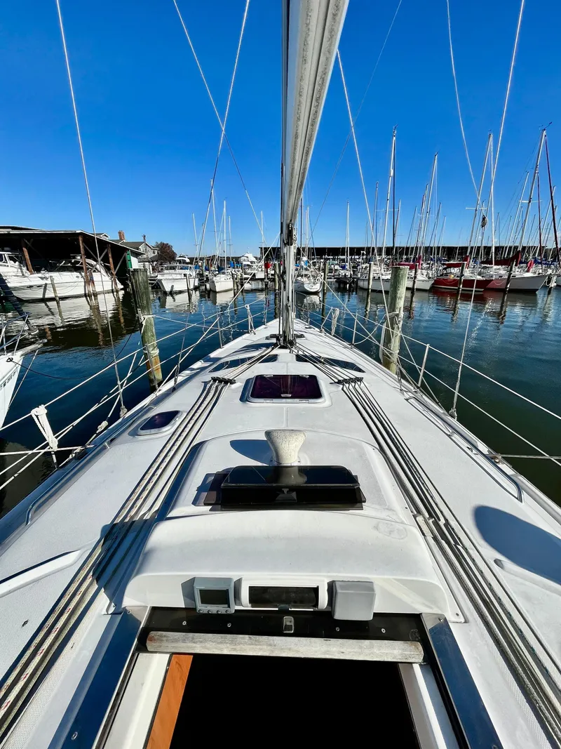 Slide: The Image of 2008 Hunter 38 sailboat docked in marina, clear blue sky, calm waters. - 9