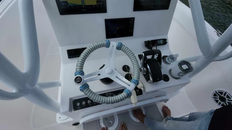 Slide: The Image of 2023 CG Boat Works 35 M-Series helm with steering wheel and navigation controls. - 13