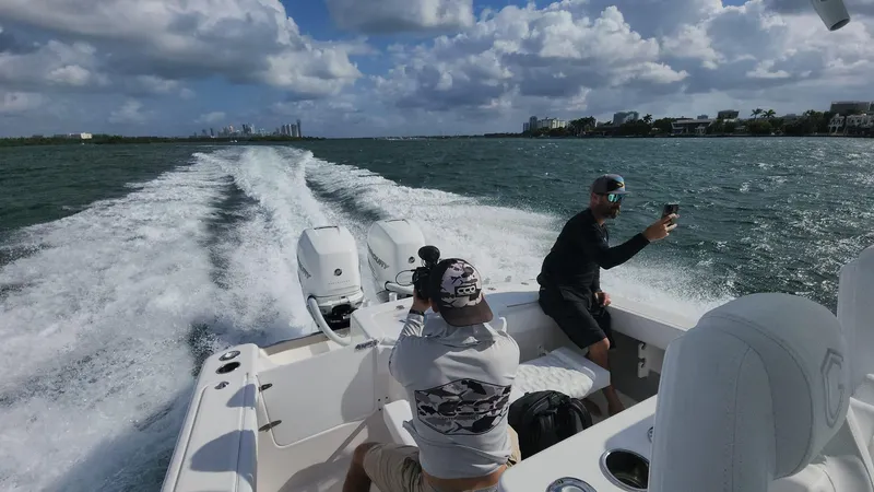 Slide: The Image of People enjoying a ride on a 2023 CG Boat Works 35 M-Series boat. - 15