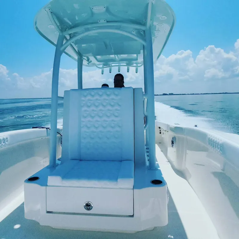 Slide: The Image of 2023 CG Boat Works 35 M-Series cruising on open water under clear skies. - 16